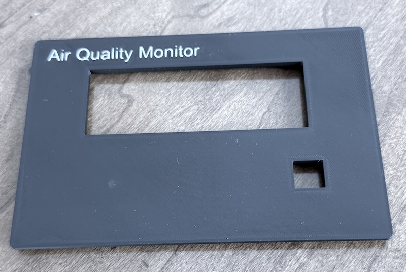 Finished lid with white "Air Quality Monitor" text on a matte black lid